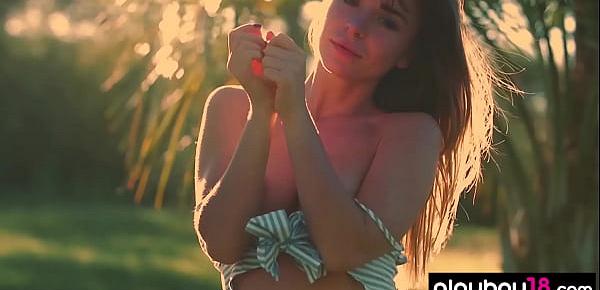  All natural teen Lillii stripping slowly on a meadow